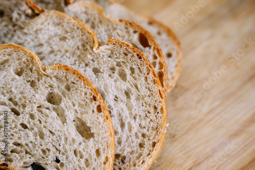 Freshly baked sourdough bread loaf with a crispy crust, partially sliced for eating