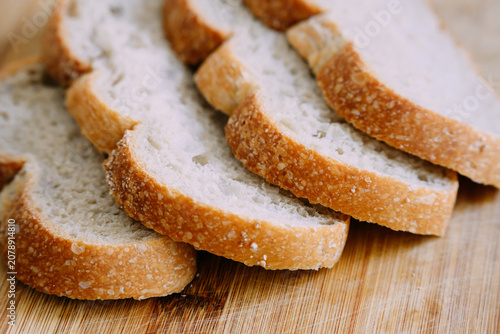 Freshly baked sourdough bread loaf with a crispy crust, partially sliced for eating