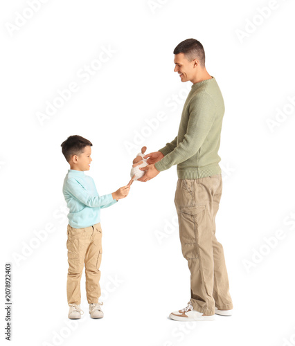 Young man giving toy to his...