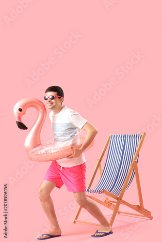 Young man with swim ring an...