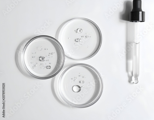 Laboratory glassware with clear liquid and dropper for scientific research.