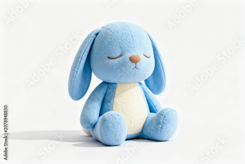 A soft blue stuffed bunny toy with closed eyes, sitting on a plain white background, a gentle plush animal figure.