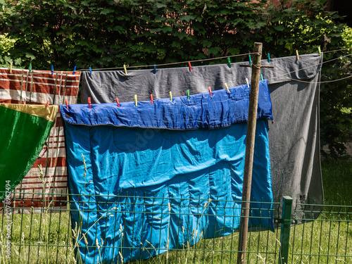 laundry is drying on a line in the courtyard of a multi-story building