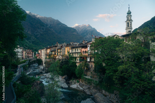 Sunset view of Chiavenna old town with Mera river, Lombardy, Italy
