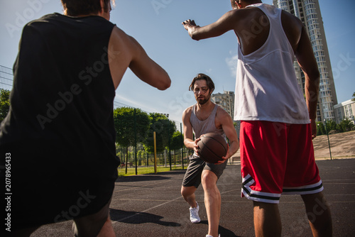 Fotografi Multicultural friends enjoying a thrilling basketball game during summer