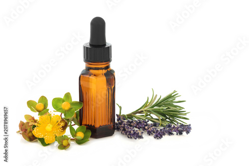 Lavender, rosemary, St Johns Wort herbs used in herbal medicine, treats depression, tincture bottle on white. Natural healing for depressed states of mind.  