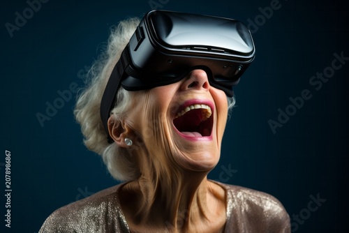 Astonished senior woman with virtual realty headset (VR) with dark background. New Technology Concept, Cyber Glasses