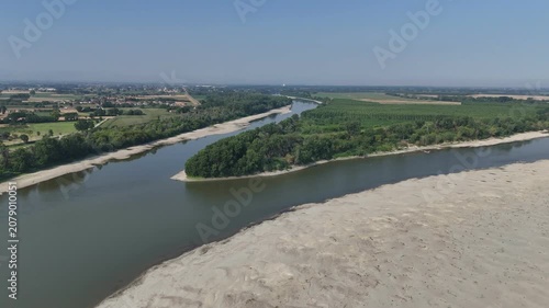 River Po experiencing extreme low water levels due to drought and climate change, revealing sandbanks and impacting water scarcity in Lombardy and Emilia Romagna, Italy