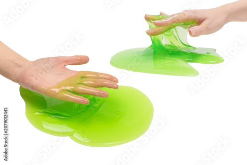 Schilderij op canvas Green slime toy in woman hand isolated on white background.