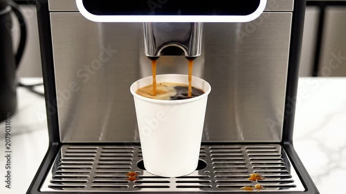 Close-Up View of a Professional Coffee Vending Machine Dispensing Fresh Brewed Coffee into a White Paper Cup at a Modern Kitchen Setting