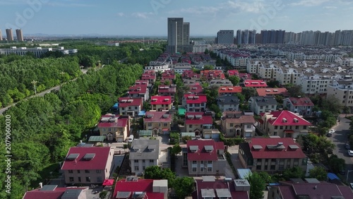 Foto Aerial view of red-roofed residential area in Shouguang with urban landscape and
