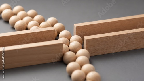 Wooden beads flowing through narrow gap between timber blocks illustrates bottleneck constraint and capacity limits in business process optimization management