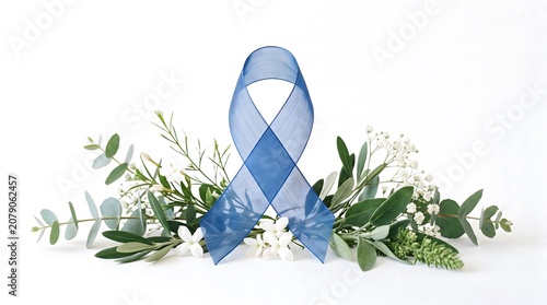 Blue awareness ribbon for prostate cancer, colon cancer, or child abuse prevention campaign and beautifully decorated with green eucalyptus leaves