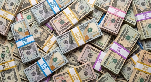 Photos A large pile of US dollar bills in various denominations neatly bundled and stac