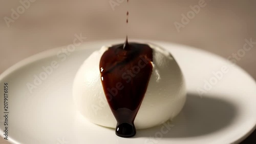 Mozzarella cheese ball drizzled with balsamic glaze in food