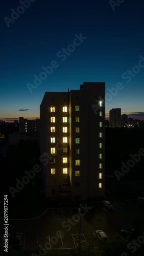 High angle time lapse of multi story residential building during golden sunrise transition