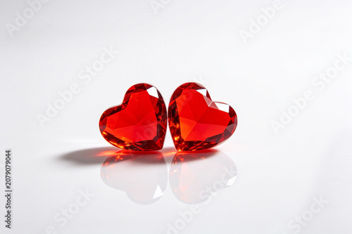 Two red crystal hearts isolated on white background