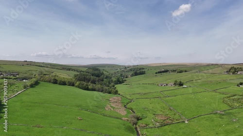 High aerial view of hebden water in Colden near heptonstall surrounded by grazing sheep in meadows and farmhouses in West Yorkshire landscape