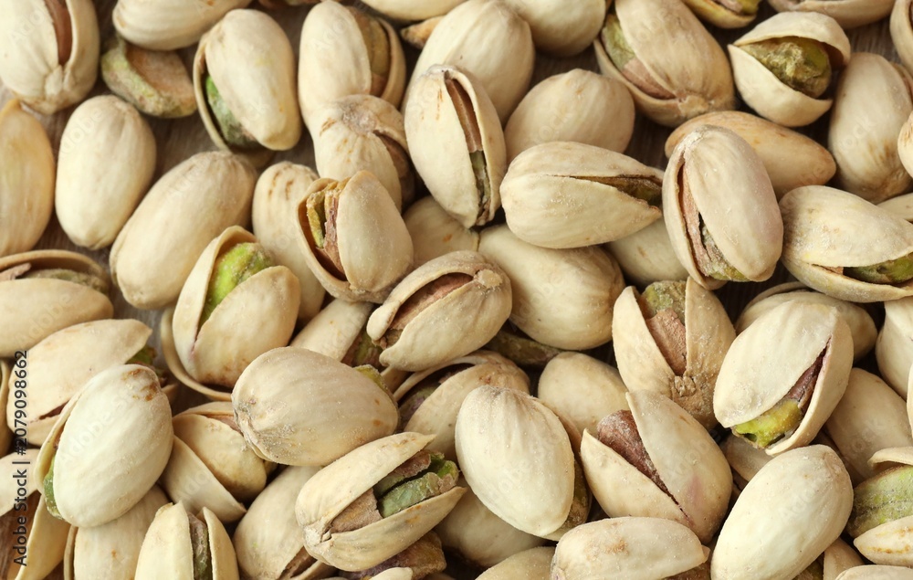 Fototapeta premium A photo of a pile of pistachios, with the majority still in their shells. Big amount of pistachios