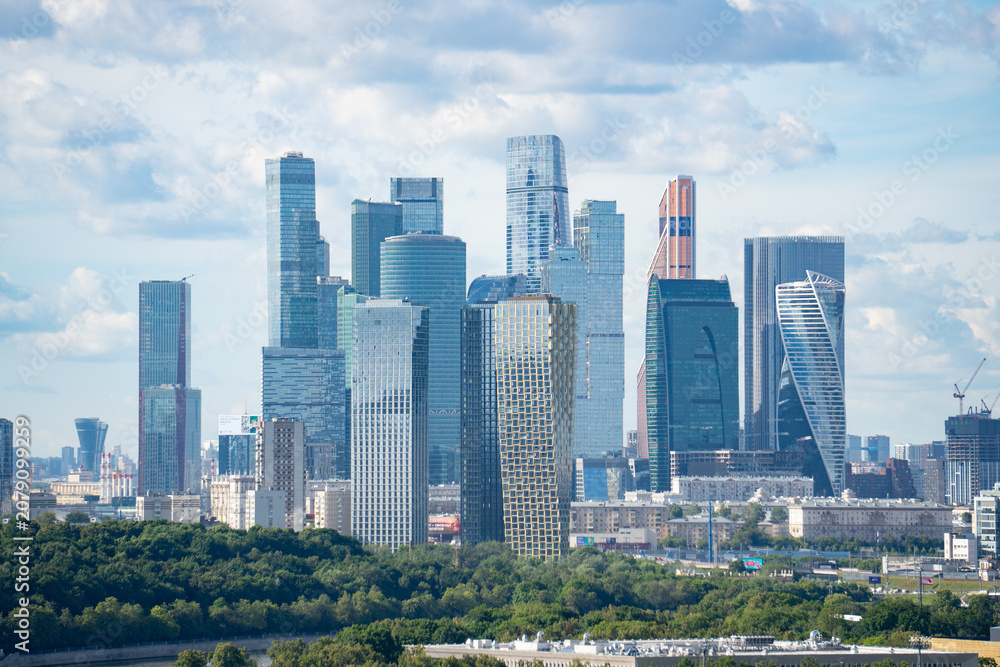 Obraz premium Epic Moscow City international business center skyscrapers vertical panorama. Cinematic view of modern futuristic office glass towers district, urban financial center facade skyscrapers and green pa