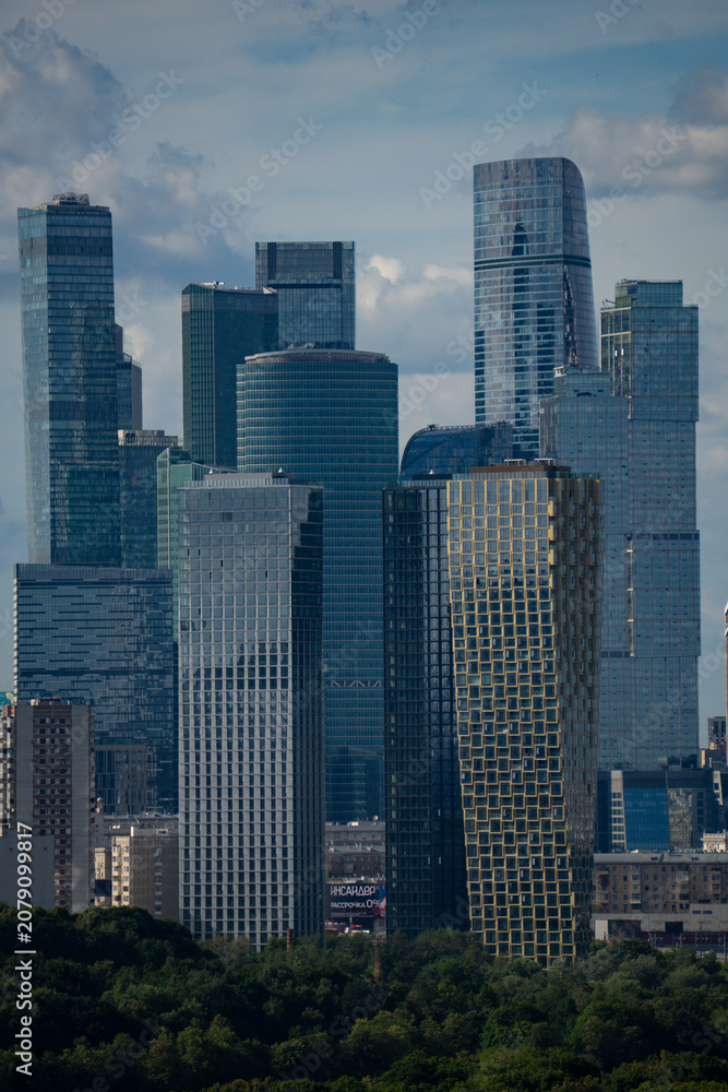 Fototapeta premium Epic Moscow City international business center skyscrapers vertical panorama. Cinematic view of modern futuristic office glass towers district, urban financial center facade skyscrapers and green pa