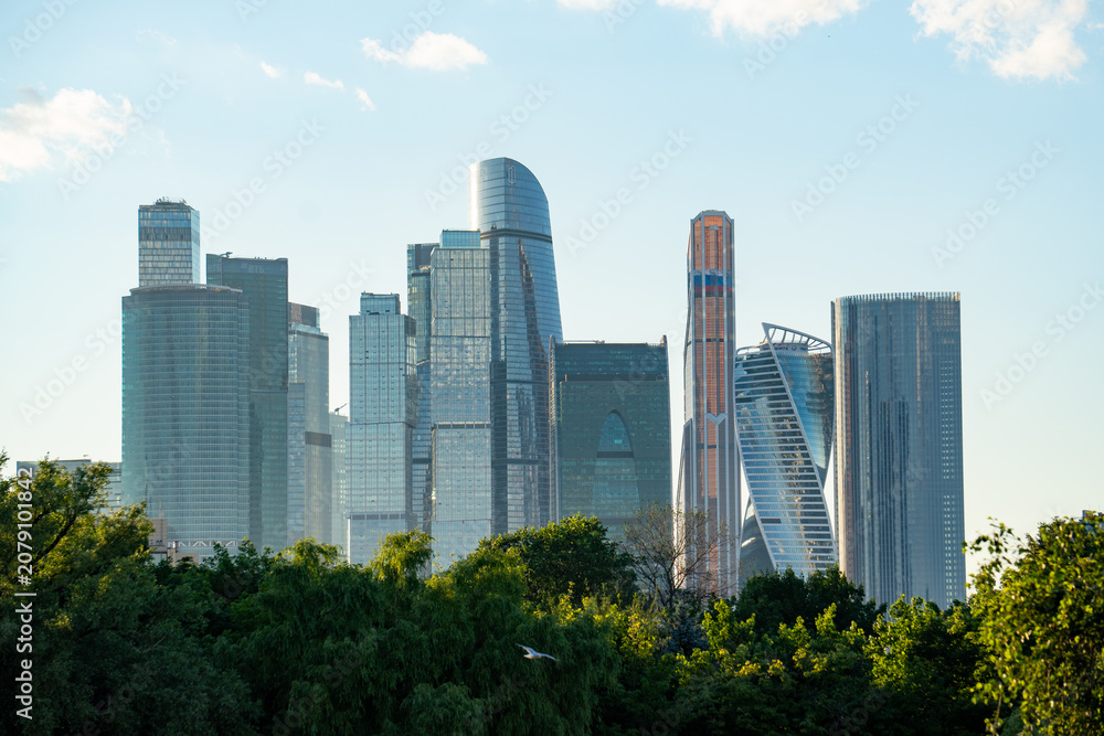 Obraz premium Epic Moscow City international business center skyscrapers landscape panorama. Cinematic horizontal view of modern office glass towers district, urban financial center facade skyscrapers and green p