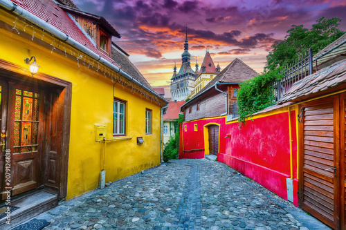 Bild auf Leinwand Remarkable evening view of historic town Sighisoara and Clock Tower built by Saxons