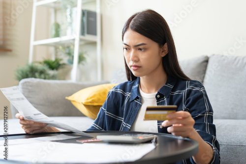 фотографія Business financial concept, stressed asian young woman hand checking list statem