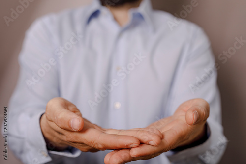 Konstfotografi Close-up of a man's open hands, palms up, in a gesture of offering or receiving