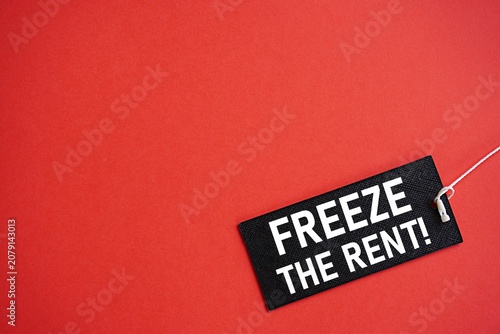 FREEZE THE RENT printed black card. Financial concept. Real estate rental business. Rent increase. Maintain rent. Blank background for text. Background for writing and pictures. For various uses
