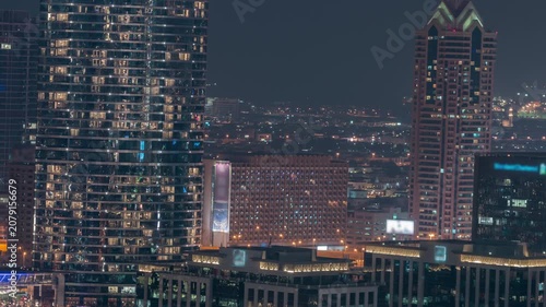 Metropolitan night skyline timelapse footage recorded during night within Downtown Dubai. Countless distant city lights create a vibrant glowing carpet across the vast urban landscape.