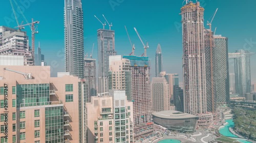 Metropolitan construction site aerial timelapse showcasing the environment in Downtown Dubai. The massive ongoing engineering projects are highly visible among the finished structures.