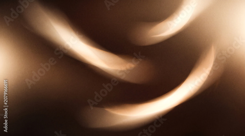 Abstract golden light streaks with soft brown background for elegant design and modern texture