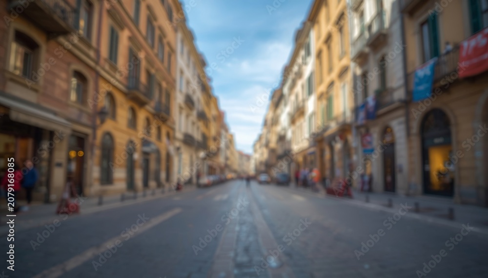 Fototapeta premium There is a blurry image of a city street with people walking on it