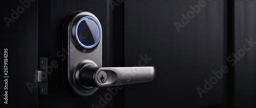 Close up of biometric fingerprint smart door lock on elegant matte black door with glowing LED