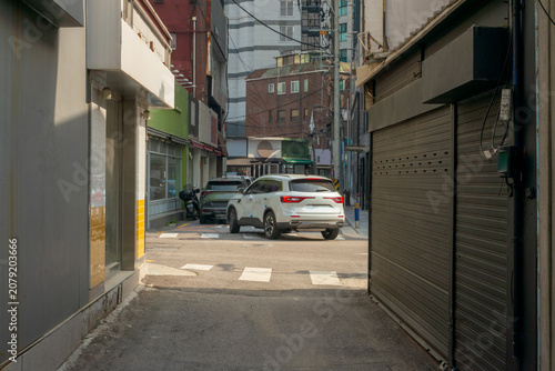 Narrow Residential Alley Leading to Modern City Street