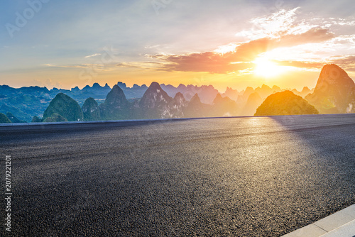 Empty asphalt road and majestic karst mountain peaks at sunset in Guilin, China