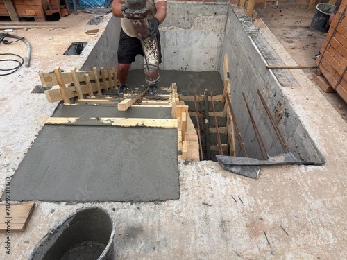 Photos Construction worker using concrete pump hose to pour concrete into stairs formwork, building site, industrial, engineering, infrastructure