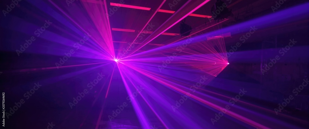 Obraz premium Violet and magenta laser spectacle highlighting innovative lighting technology