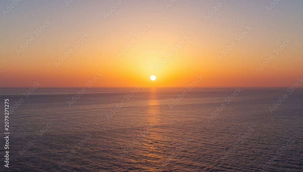 Obraz premium Sunset over calm ocean waters