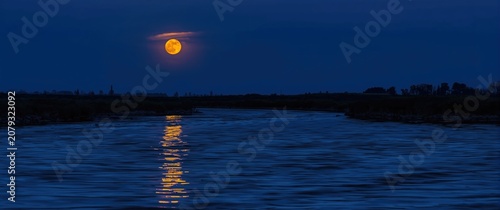 Full moon reflecting on a r...