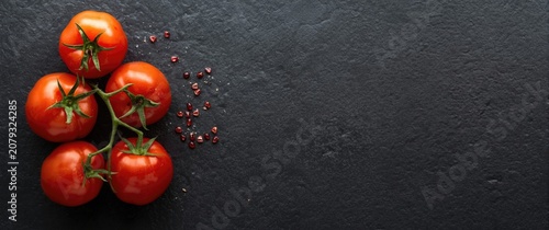 Fresh red tomatoes on a dar...