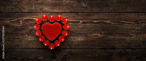 Red heart-shaped candles ar...