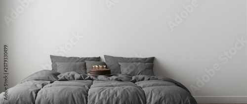 Gray bedding with a cake on...