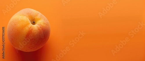 Ripe peach on a vibrant ora...