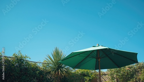 Green patio umbrella in a s...