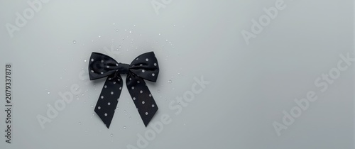 Black polka dot bow on a gr...