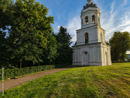 Photography White stone chapel with steeple bell cross, and arched doors in summer sun day u
