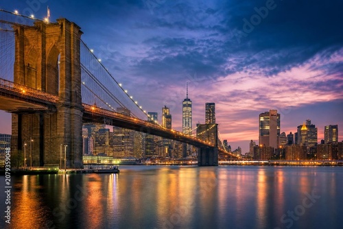 A city bridge at twilight, featuring warm lights and a dramatic skyline in an urban landscape.