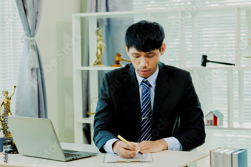 Fotografie Innovative law consultant analyzing statutory codes and building defense modeling on laptop